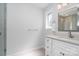 Bathroom with white cabinetry, a window, and a glass enclosed shower at 5424 Doncaster Dr, Charlotte, NC 28211