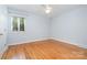Empty bedroom featuring wood floors, neutral walls, and a double-hung window at 5424 Doncaster Dr, Charlotte, NC 28211