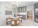 Dining area with modern lighting and a round table with white chairs near gray kitchen cabinets at 5424 Doncaster Dr, Charlotte, NC 28211