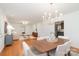 Open concept dining room featuring hardwood floors and modern lighting at 5424 Doncaster Dr, Charlotte, NC 28211