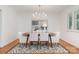 An inviting dining room with hardwood floors and a modern chandelier for elegant meals at 5424 Doncaster Dr, Charlotte, NC 28211