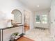 Bright foyer with tiled floors, a console table, and double doors leading outside at 5424 Doncaster Dr, Charlotte, NC 28211