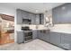 Gray kitchen boasting stainless steel appliances, ample cabinetry, and modern tile flooring at 5424 Doncaster Dr, Charlotte, NC 28211