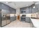 Stylish kitchen with gray cabinets, stainless steel appliances, and bright countertops at 5424 Doncaster Dr, Charlotte, NC 28211