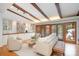 Spacious living room with wood beams, hardwood floors and sliding doors to the outside at 5424 Doncaster Dr, Charlotte, NC 28211