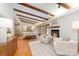 Bright living room featuring a fireplace, wood beams and hardwood flooring at 5424 Doncaster Dr, Charlotte, NC 28211