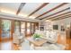 Bright living room boasting wood beams, hardwood floors and access to the outdoors at 5424 Doncaster Dr, Charlotte, NC 28211