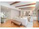 Bright living room featuring hardwood floors, wooden ceiling beams, a neutral color palette, and built-in shelving at 5424 Doncaster Dr, Charlotte, NC 28211