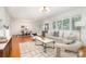 Bright living room featuring hardwood floors, white walls, and stylish neutral furniture at 5424 Doncaster Dr, Charlotte, NC 28211