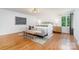 Sun-filled main bedroom showcases hardwood floors, a neutral palette, and an accent chair at 5424 Doncaster Dr, Charlotte, NC 28211