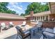Backyard patio with multiple seating areas and brick retaining walls at 5424 Doncaster Dr, Charlotte, NC 28211