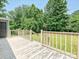 Wood deck with railings overlooking a lush green yard at 5811 Rock Hollow Dr, Charlotte, NC 28212