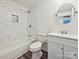 Bathroom with a tub and shower combo and white marble tile surround at 5811 Rock Hollow Dr, Charlotte, NC 28212