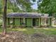 Charming single-story home featuring a black front door and lush green surroundings at 5811 Rock Hollow Dr, Charlotte, NC 28212