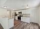 Modern kitchen with stainless steel appliances and hardwood floors at 5811 Rock Hollow Dr, Charlotte, NC 28212