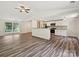 Bright, open-concept living space with modern kitchen and hardwood floors at 5811 Rock Hollow Dr, Charlotte, NC 28212