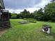 Spacious backyard featuring garden beds, a lush green lawn, stairs and various plants at 6229 Mountain Grove Rd, Hickory, NC 28602