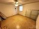 Small room with concrete walls and colorful linoleum floors, plus a window at 6229 Mountain Grove Rd, Hickory, NC 28602