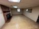Spacious basement featuring a brick fireplace, neutral walls, and a window offers versatile living or storage space at 6229 Mountain Grove Rd, Hickory, NC 28602