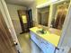 Retro bathroom with a vanity, large mirror, tile accents, and view of the shower-tub with curtain at 6229 Mountain Grove Rd, Hickory, NC 28602