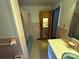 Full bathroom with pastel tile, a bathtub with shower curtain, and a vanity with a large mirror at 6229 Mountain Grove Rd, Hickory, NC 28602