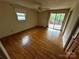Bedroom with hardwood floors, a ceiling fan, a window, and sliding glass doors to the balcony at 6229 Mountain Grove Rd, Hickory, NC 28602