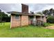 Brick home with a covered porch and mature greenery offers a cozy and inviting entrance at 6229 Mountain Grove Rd, Hickory, NC 28602