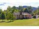 Traditional single-Gathering home boasts a brick facade, front porch, and a lush green lawn at 6229 Mountain Grove Rd, Hickory, NC 28602