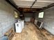 Inside of the garage which contains block walls, a drop down door, an old stove and windows at 6229 Mountain Grove Rd, Hickory, NC 28602