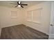 Bedroom featuring neutral walls, updated gray vinyl floors, ceiling fan and multiple windows at 706 Mcintyre St, Monroe, NC 28110