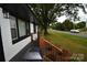 View of the front porch with wood railings and black columns at 706 Mcintyre St, Monroe, NC 28110