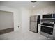 Bright kitchen with stainless steel appliances, granite countertops, and marble flooring at 706 Mcintyre St, Monroe, NC 28110