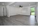 Bright living room featuring neutral walls, updated gray vinyl floors, ceiling fan and an open door entrance at 706 Mcintyre St, Monroe, NC 28110