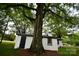 Outdoor shot of a storage building showing window and black door at 706 Mcintyre St, Monroe, NC 28110