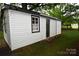 A functional outbuilding with fresh siding and a dark colored door providing extra storage space at 706 Mcintyre St, Monroe, NC 28110