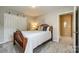 Cozy bedroom with neutral walls, a decorative headboard, and a doorway leading to another room at 714 Deerbrook Ln, Tega Cay, SC 29708