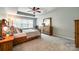 Relaxing bedroom with tray ceiling, plush carpet, and a large window for plenty of light at 714 Deerbrook Ln, Tega Cay, SC 29708