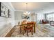 Spacious dining room with elegant lighting, neutral walls, and seamless flow into the adjacent living spaces at 714 Deerbrook Ln, Tega Cay, SC 29708