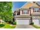 Charming townhome exterior with stone accents, a two-car garage, and well-manicured landscaping at 714 Deerbrook Ln, Tega Cay, SC 29708