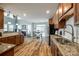 Spacious kitchen with granite countertops, wooden cabinetry, and an open view to the cozy living area at 714 Deerbrook Ln, Tega Cay, SC 29708
