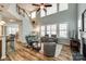 Inviting living room featuring wood floors, comfortable seating, and large windows for ample natural light at 714 Deerbrook Ln, Tega Cay, SC 29708
