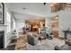 Open concept living area flows into the kitchen, highlighting wood floors and a cozy fireplace at 714 Deerbrook Ln, Tega Cay, SC 29708