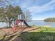 Community playground with slide and climbing rock features, perfect for Gathering fun by the water at 714 Deerbrook Ln, Tega Cay, SC 29708