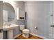 Clean and modern powder room with pedestal sink, wood flooring, and sleek fixtures at 714 Deerbrook Ln, Tega Cay, SC 29708