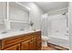 Bright bathroom featuring a vanity, toilet, and tub with tiled walls and a shower head at 729 Tenth Ne Ave, Hickory, NC 28601