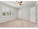 Neutral bedroom featuring carpet, ceiling fan, and a shuttered window at 729 Tenth Ne Ave, Hickory, NC 28601
