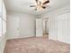 Neutral bedroom featuring carpet, ceiling fan, and multiple closets and doorways at 729 Tenth Ne Ave, Hickory, NC 28601