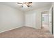 Neutral bedroom featuring carpet, ceiling fan, and a double closet at 729 Tenth Ne Ave, Hickory, NC 28601