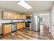 View of the kitchen with wood cabinets, stainless steel appliances, and hardwood floors at 729 Tenth Ne Ave, Hickory, NC 28601