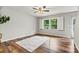 Living room featuring hardwood floors, large window, and ceiling fan at 729 Tenth Ne Ave, Hickory, NC 28601